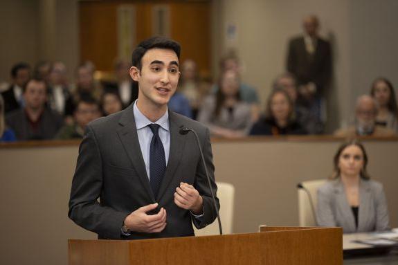 An action shot of a student in a courtroom